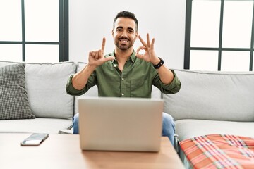 Canvas Print - Young hispanic man having video call speaking with deaf language at home