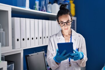 Sticker - Young caucasian woman scientist using touchpad at laboratory