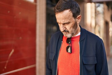 Canvas Print - Middle age man with relaxed expression standing at street