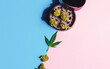 Cannabis flower buds Medical Marihuana leafs and grinder on pink blue background