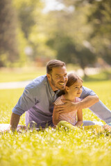 Wall Mural - Father with daughter having fun at the park