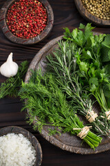 Wall Mural - Fresh green herbs, mint, parsley, dill and rosemary on the dark wooden background