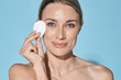 © Peakstock - Makeup and removal skin care and cleansing. Beautiful woman with cosmetic cotton pad near her face taking care of skin