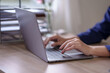 © amnaj - Woman hand who are actively typing and concentrate on work using laptop computer at the office.