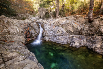 Sticker - L'Agnone river cascades over rocks into a natural pool in the forest of Vizzavona alongside the GR20 trail in Corsica