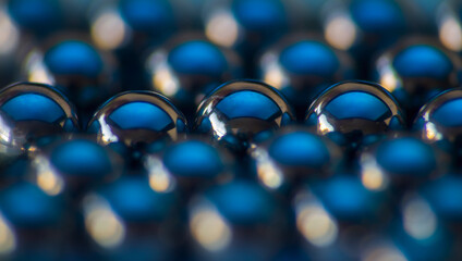 Wall Mural - metal small sphere shined with blue light. macro photo, abstract background