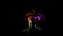 Little girl moves her fingers across the surface of the plasma magic lamp ball