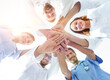 © ASDF - bottom view.a team of doctors at the medical center clasped their hands together
