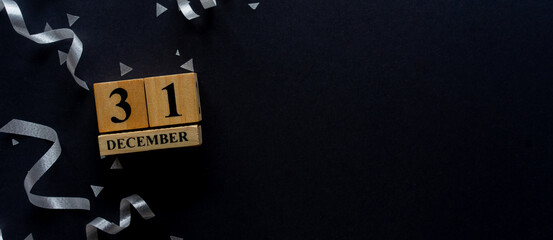 Wall Mural - close up number 1 january cube shape wood with silver color of rolling ribbon and confetti on black 