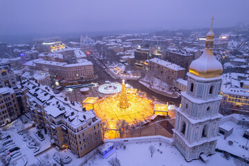 Christmas tree with lights outdoors at night in Kiev. Sophia Cathedral on background.