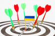 © Dzmitry - Darts with the flag of Ukraine in the bullseye, next to red and green darts.