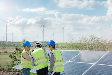 engineer man inspects construction of solar cell panel or photovoltaic cell by electronic device. Industrial Renewable energy of green power. factory worker working on tower roof.