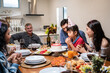 © Kawee - Multi-ethnic big family having a birthday party for young kid daughter.