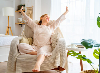 Canvas Print - woman resting on armchair at home