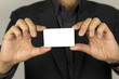 © Paradox-D - A man's hand holding white card for inter card concept design, and smart dart man showing white mock up ID card on white background.