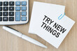 © Volha - TRY NEW THINGS words written in an office card