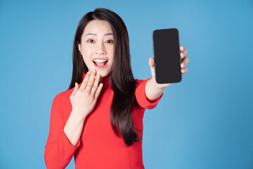 Wall Mural - Photo of young Vietnamese woman wearing red ao dai