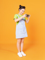 Wall Mural - Full length image of young Asian woman standing on background