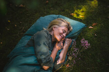 Smiling Mature Woman Sleeping In Garden