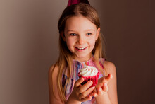 Portrait Of Happy Little Girl With Cup Cake