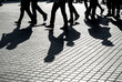 © Westend61 - Shadows of people walking on pavement