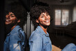 © Westend61 - Happy woman enjoying sunlight in living room at home