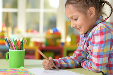 Wall Mural - Cute little preschooler child drawing at home