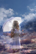 An elegant woman in a white dress and an umbrella between clouds is holding a rose that has similar colors like the morning sun.