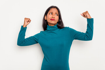 Wall Mural - Young Indian woman isolated on white background showing strength gesture with arms, symbol of feminine power