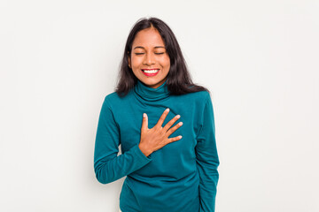 Wall Mural - Young Indian woman isolated on white background laughs out loudly keeping hand on chest.