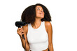 © Asier - Young African American woman holding a hairdryer isolated dreaming of achieving goals and purposes