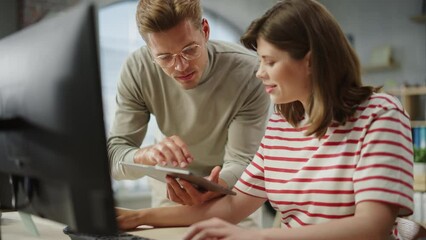 Poster - Portrait of Two Creative Young Colleagues Consulting Eachother Using Computer and Tablet. White Male Supervisor Discussing Scheduling with Female Caucasian Head of Operations. Slow Motion.