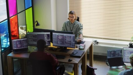 Poster - Diverse Colleagues Writing Code on Desktop Computers With Professional Multiple Monitors Setup. Software Development Department Working on Software as a Service Platform For Business Clients.