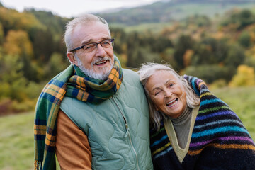 Wall Mural - Senior couple in love huging each other in autumn nature.