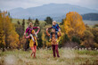 © Halfpoint - Happy parents with their little kids on piggyback at autumn walk, in the middle of colourfull nature. Concept of healthy lifestyle.