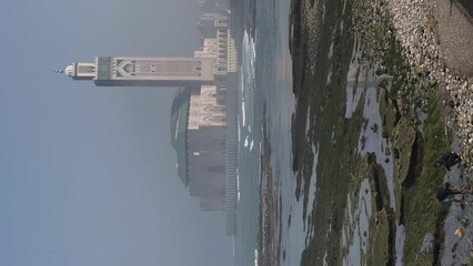 Wall Mural - View of Hassan II mosque in a hot day - Casablanca, Morocco - Vertical 4K Video