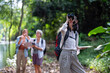 Backpack tourist travel outdoor adventure bird study using binoculars looking and record to book