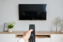 Woman Watching Tv With Remote Control Indoors