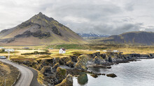 Arnarstapi Is A Tiny Fishing Village Situated At The Foot Of Mt. Stapafell In Iceland, Thriving Tourism Destination With Scenic Landscape