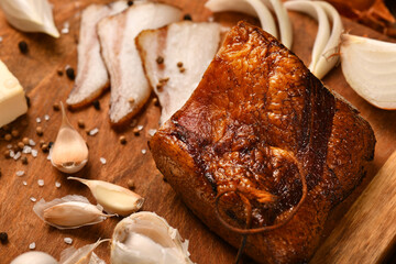 still life of food in a rural style on a dark wood background, sliced lard and garlic, cheese and onion, concept of fresh vegetables and healthy food