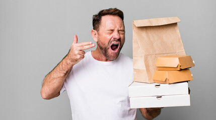 middle age man looking unhappy and stressed, suicide gesture making gun sign. delivery and fast food take away concept