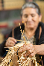 Senior Hispanic Woman Crafting Grass Basket