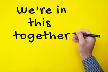 Teamwork quote text on yellow cover background - We are in this together.