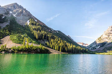 Creater Lake in Colorado Maroon Bells area with rocky mountain snow peak view in summer with nobody and reflection in beautiful green water