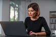 © VideoFlow - Inspired attractive businesswoman is typing on laptop at office workplace