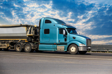 Canvas Print - American truck with tipper semi-trailer moves along road.