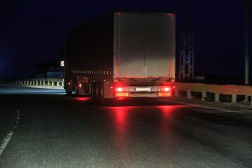 Wall Mural - truck moves at night on a country road