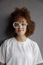 Portrait Happy Young Woman In Retro Eyeglasses With Curly Hair