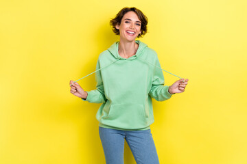 Photo of overjoyed nice cute lady dressed comfort warm fashionable sweatshirt satisfied purchase isolated on yellow color background