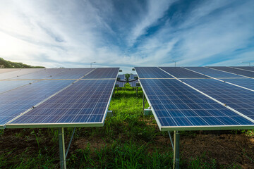 Wall Mural - Photovoltaic solar power panel on dramatic sunset blue sky background, green clean Alternative power energy concept.